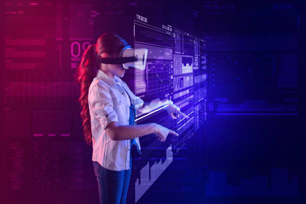 istock Calm girl pointing to the hologram while being in a virtual reality 1003779008