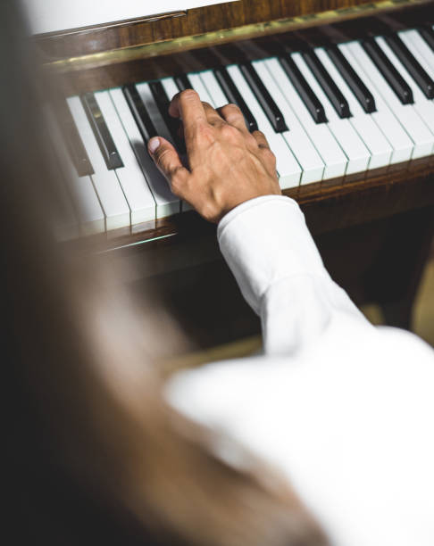 istock Young Woman Playing Piano Close-up Shot 1003780150