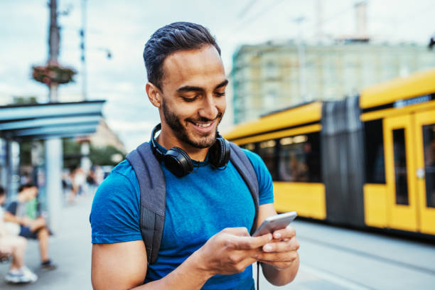 istock Young entrepreneur using mobile app to see the tram schedule 1003783272