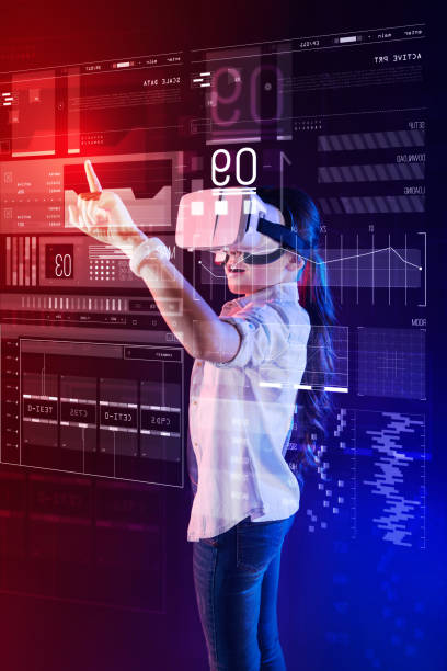 istock Emotional girl feeling impressed while studying in virtual reality glasses 1003786290