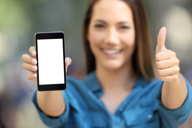 istock Positive woman showing a blank smart phone screen 1003786752