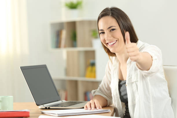 istock University student gesturing thumbs up at home 1003787126