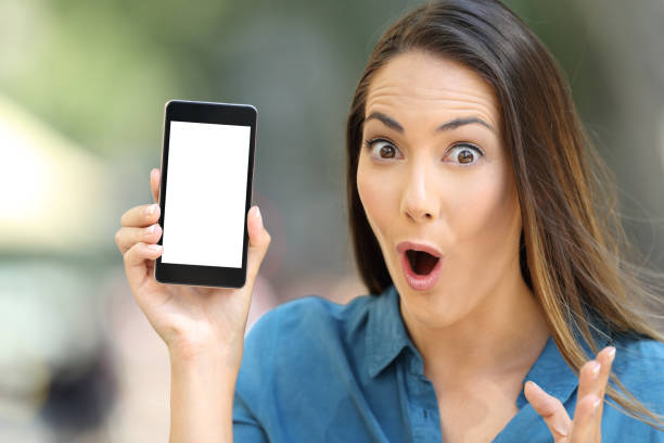 istock Amazed woman showing a blank smart phone screen 1003787474