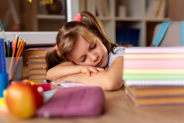 istock Tired little girl sleeping 1003788780