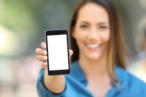 istock Girl hand showing a phone screen mock up 1003790030