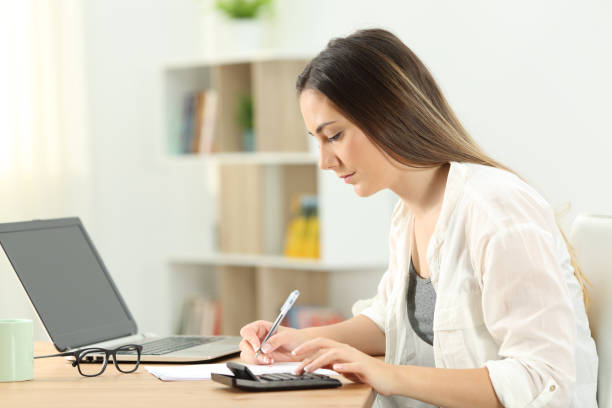 istock Serious woman doing accounting at home 1003790578