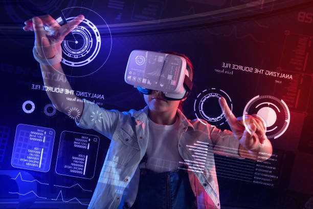 istock Smart girl touching round icons on the screen while using virtual reality glasses 1003791298