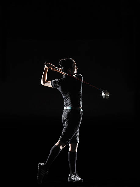 the lady golfer swings the driver of golf - golf athlete foto e immagini stock