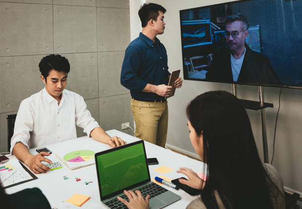 istock Video conference meeting presenting project to a group of managers 1003801628