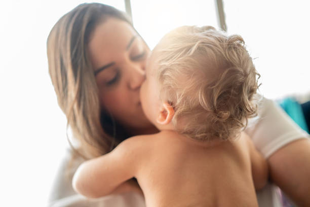 Mother Kissing Your Little Cute Baby at Home Baby kissing on the mouth stock pictures, royalty-free photos & images