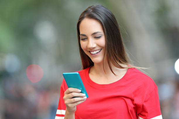 istock Happy woman reads a message on a smart phone 1003816574