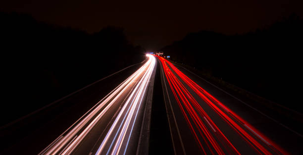 istock car lights at highway at night with long shutter speed 1003817196