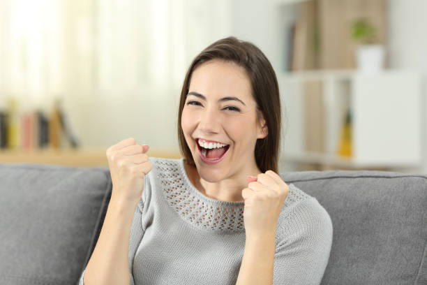 istock Excited woman looking at camera at home 1003817402