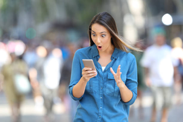 istock Shocked woman reading smart phone messages 1003819690