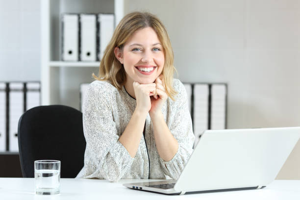 istock Satisfied employee looking at camera at office 1003819882