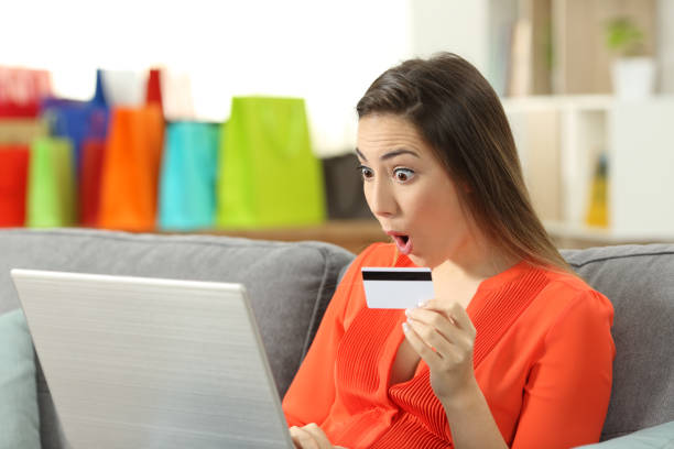 istock Surprised lady buying online paying with credit card 1003820068