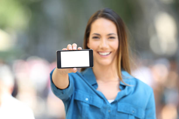 istock Woman showing a blank horizontal phone screen 1003820258