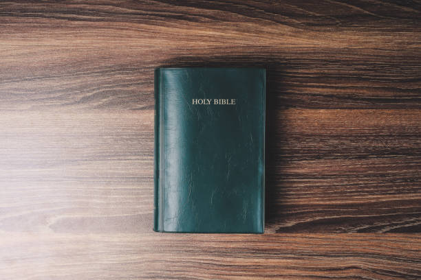 istock Holy bible on the wooden desk 1003824696