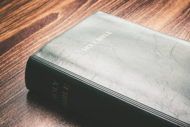 istock Holy bible on the wooden desk 1003824742