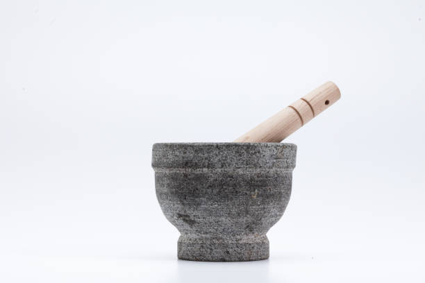 istock Stone mortar and wooden pestle isolated on white 1003824768