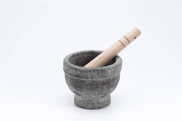 istock Stone mortar and wooden pestle isolated on white 1003826850