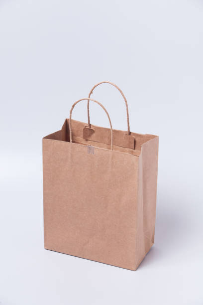 istock Brown shopping bag on gray background 1003830388