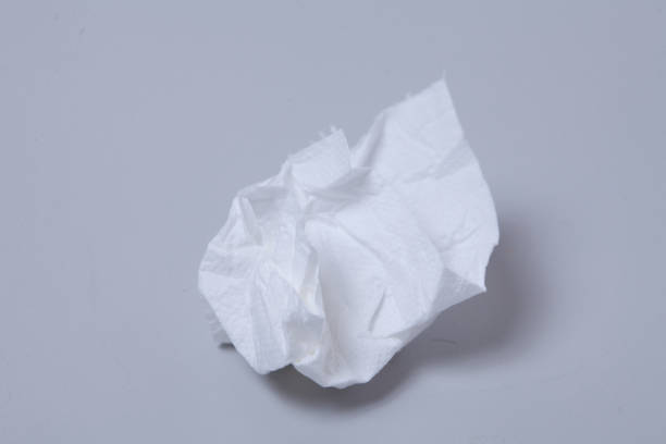 istock Crumpled toilet roll paper on gray background 1003832856