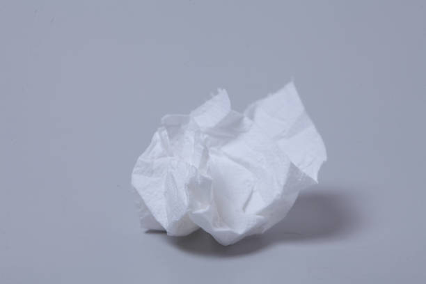 istock Crumpled toilet roll paper on gray background 1003832868