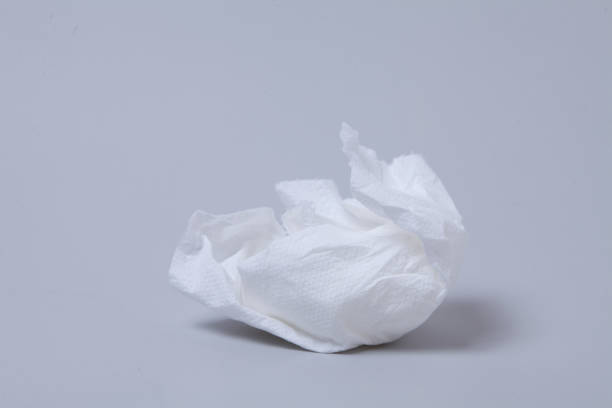 istock Crumpled toilet roll paper on gray background 1003832896