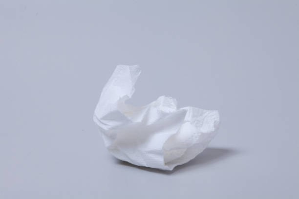 istock Crumpled toilet roll paper on gray background 1003832898