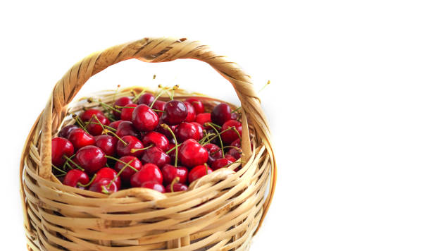 istock red cherries inside the wicker basket and isolated white background 1003858218