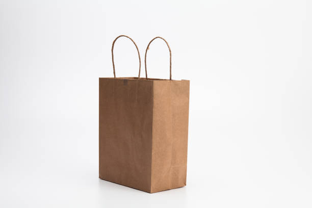 istock Empty Brown kraft shopping bag stand isolated on white background 1003861188
