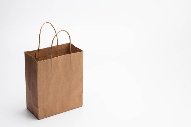istock Empty Brown kraft shopping bag stand isolated on white background 1003861218