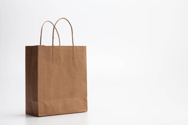 istock Empty Brown kraft shopping bag stand isolated on white background 1003861230