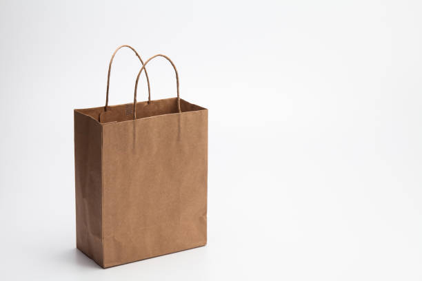 istock Empty Brown kraft shopping bag stand isolated on white background 1003861330