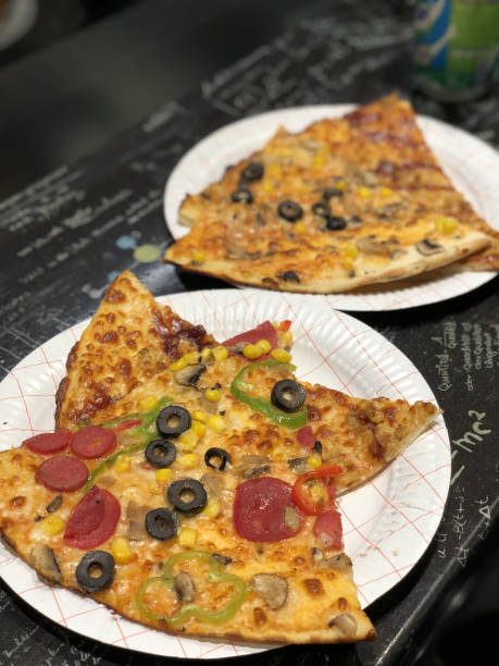 istock Fast Food Slice Pizzas on Plates 1003864172