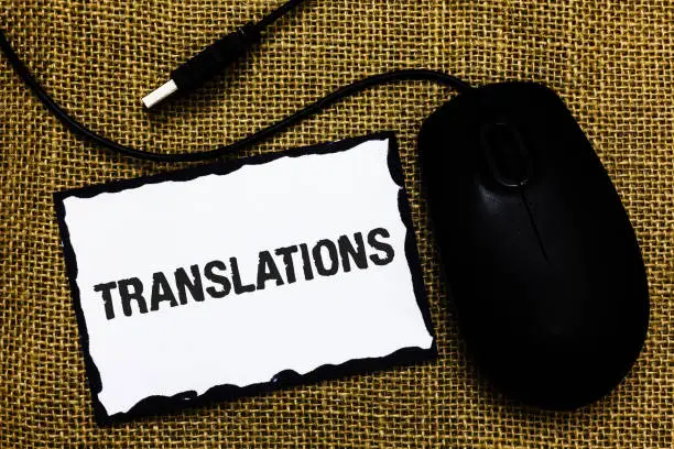 Photo of Handwriting text Translations. Concept meaning Written or printed process of translating words text voice USB black mouse art board paper ideas thoughts ideas designs mat shadow.