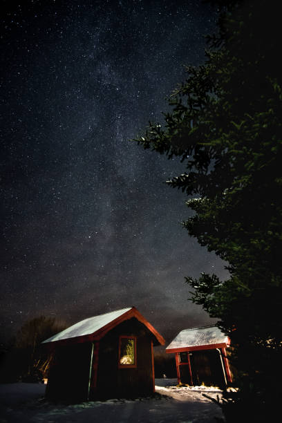 istock milky way over wooden cabin 1003875610