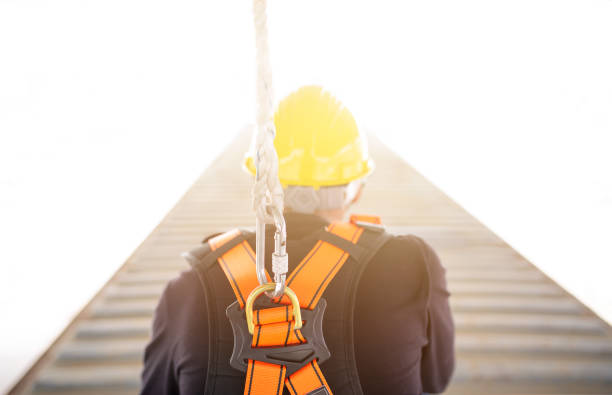 istock Industrial Worker with safety protective equipment loop and harness hanging at his back 1003885984