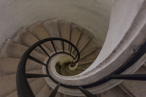 Spiral stairway leading down in a classic building in Paris