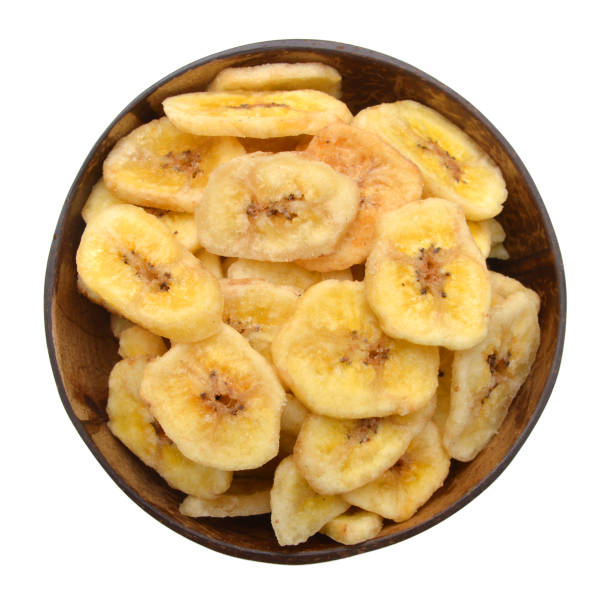 istock Banana chips in wood bowl on white background 1003892466