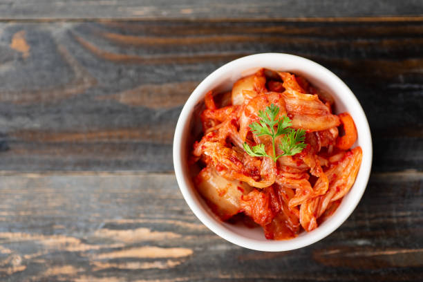 Kimchi cabbage in a bowl, Korean food Kimchi cabbage in a bowl on wooden background, top view, Korean food Kimchi stock pictures, royalty-free photos & images