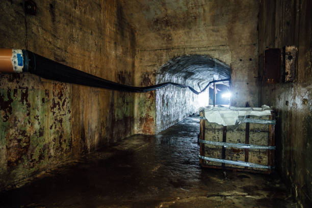 istock Dark and creepy corridor of old abandoned forgotten Soviet underground bunker 1003903884