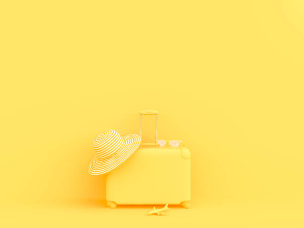 istock suitcase yellow color with sunglasses with hat and model airplane 1003904020
