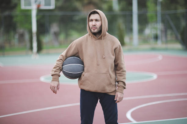istock Young man basketball player with a ball 1003904176