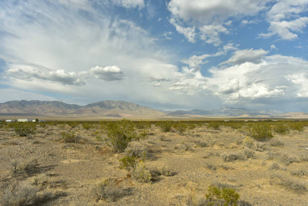 istock cloudy sky over Mojave desert valley and mountain ranges around Pahrump, Nevada, USA 1003904270