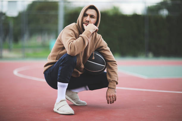 istock Young man basketball player with a ball 1003904332