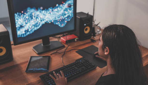 istock Young woman playing video games on computer at home 1003906600