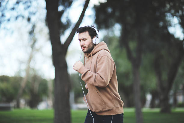 istock Sporty man running up steps in urban setting 1003907152