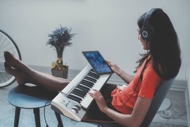 Young woman playing keyboard at home.